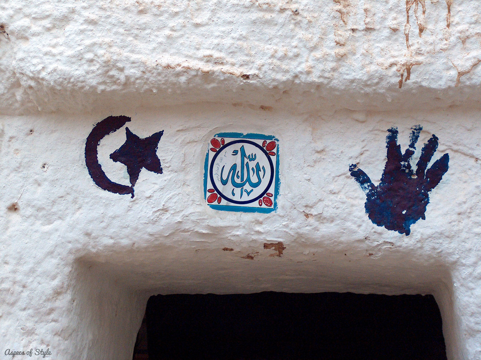 signs over the door of a house near El Djem